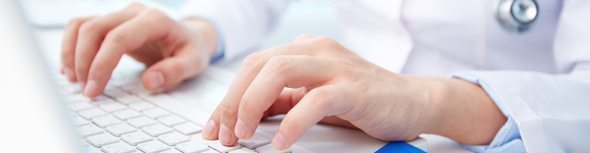 Doctor typing on a laptop